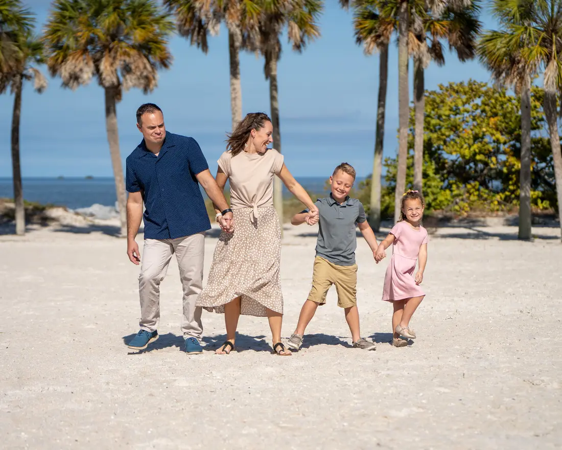 Kids running on the sand during a beach family session