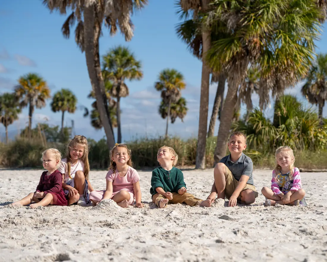 Cousins sitting together on the sand