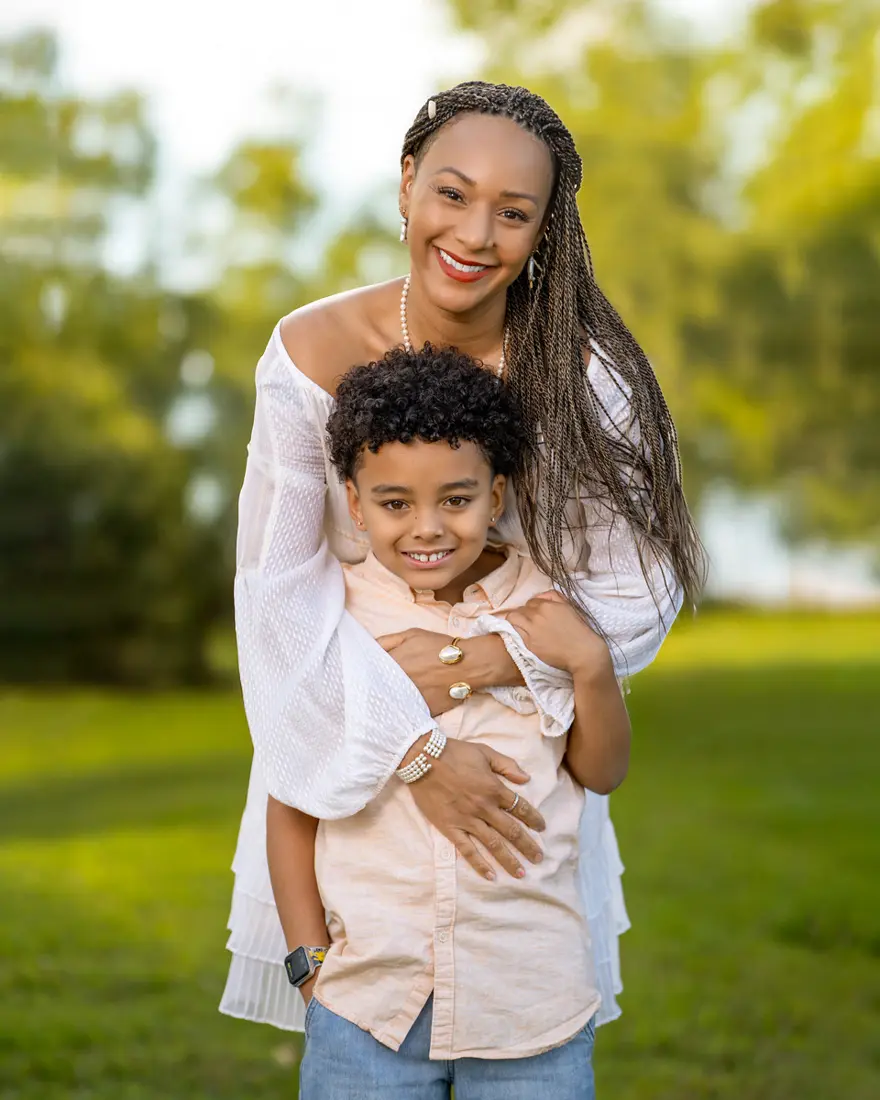Mother hugging her son outdoors at golden hour